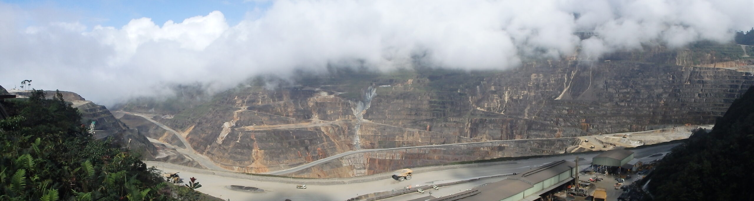 Open-cut mine benches under low cloud